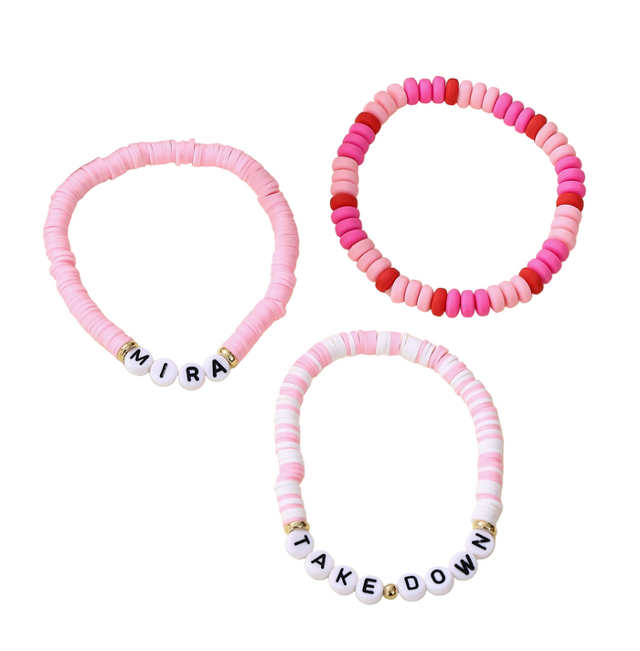 Three colorful beaded bracelets with letter beads on a light background