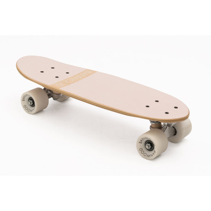 A classic-style pink Banwood cruiser skateboard with a Canadian maple deck and white high-rebound wheels.