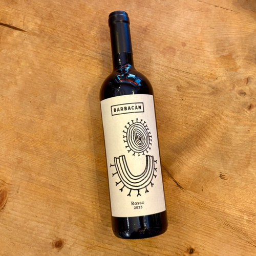 Barbacan 2023 red wine bottle, front label with circular emblem on dark glass