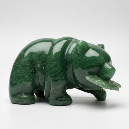 A polished green jade bear figurine holding a fish, displayed white grey background.