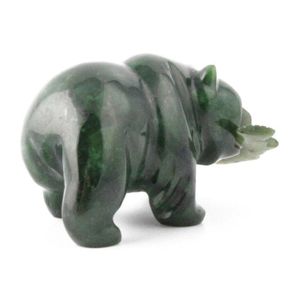 Dark green grizzly bear figurine with a fish in its mouth