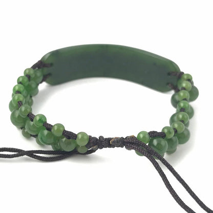 Bracelet 1833-12 green beaded bracelet with a curved central piece on dark cord
