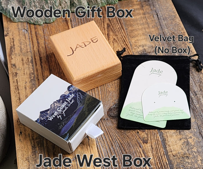 Jade West packaging includes a wooden gift box a white presentation box and a black velvet pouch with jade cards