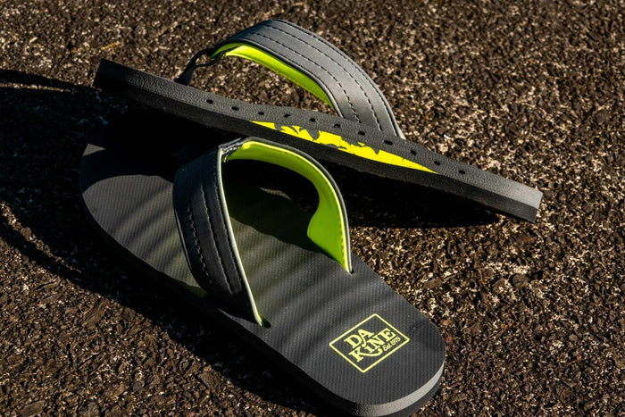 DAKINE black flip flops with neon green accents, ideal for watersports and beachwear