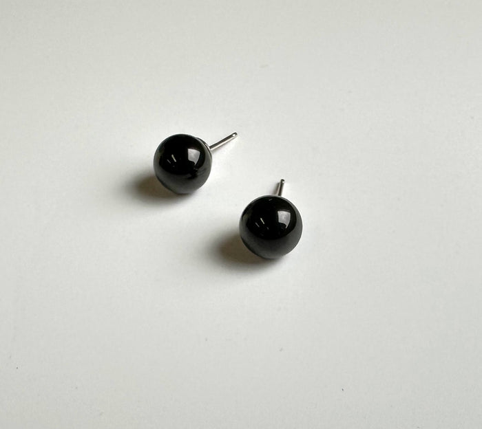 Glossy black jade ball stud earrings with silver posts on a white background