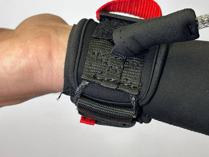 Black wing wrist leash with red pull tab for wing foiling shown on wrist