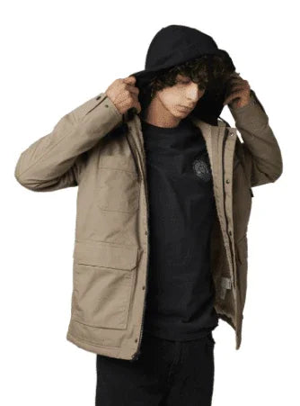 Rip Curl beige hooded jacket with front pockets, worn over black tee for watersports