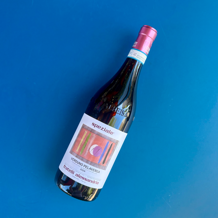 Wine bottle with pink foil top and white label featuring a red circle