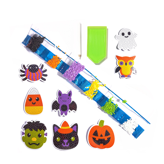 Halloween-themed craft kit with beads and accessories on a white background