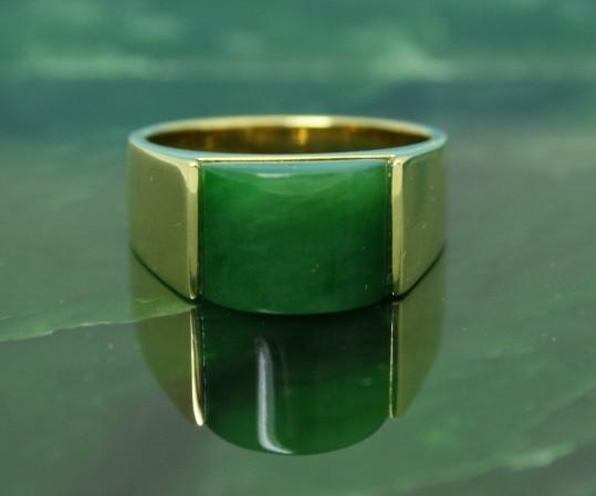 Green Jade Ring set in vermeil on a jade surface