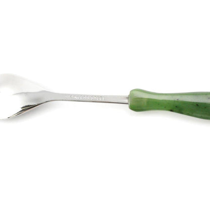 Side view of Jade sugar spoon with a glossy silver bowl and green handle
