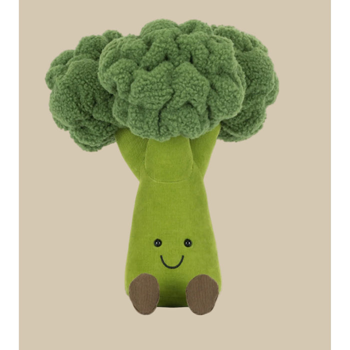 Plush toy shaped like broccoli with a smiling face on a white background