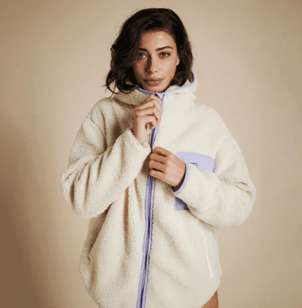 Mystic Dream Fleece Off White jacket with lavender zip and pocket, worn by woman