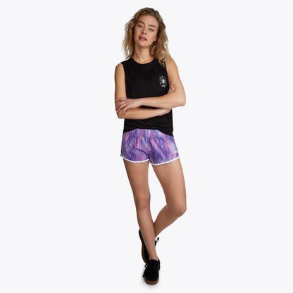 Mystic Fresh women's boardshort Hollywood Pink, model in purple print shorts