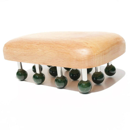 Side view of massage tool showing green knob heads on metal pegs over a rounded wooden base