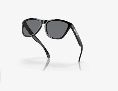 Oakley Frogskins sunglasses, polished black frame with grey lenses on white background