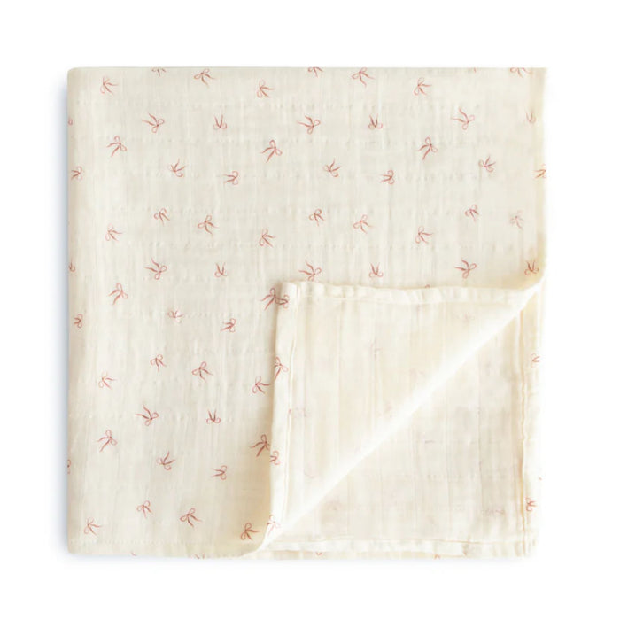 Folded fabric with subtle pattern on a white background