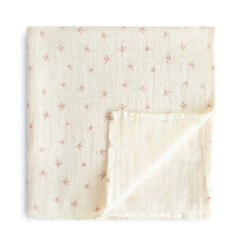 Folded fabric with subtle pattern on a white background