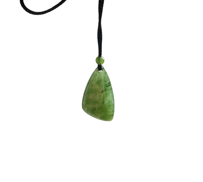 Green jade teardrop pendant on black cord with a small green bead at the knot.