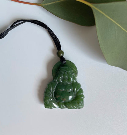 Happy Buddha pendant carved from green jade on a black braided cord with a small bead above
