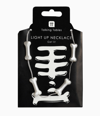 Skeleton design light-up necklace on black packaging with 'Talking Tables' branding.