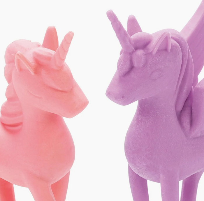 Pink and purple unicorn figurines on a white background