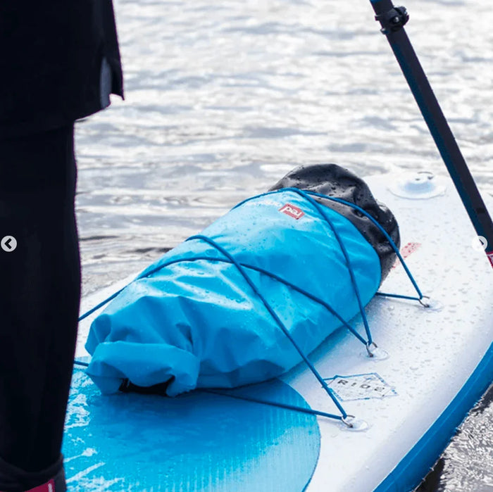 Red Paddle Co roll top dry bag 30L on paddle board with water background