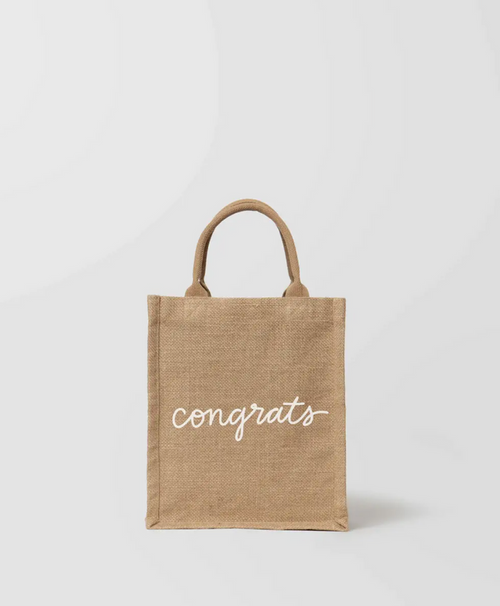 A beige cotton tote bag with the text 'CONGRATS' printed on the front.