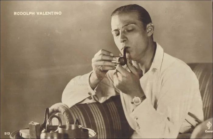 Rudolph Valentino, smoking a pipe - VINTAGEARTREPRINTS.COM