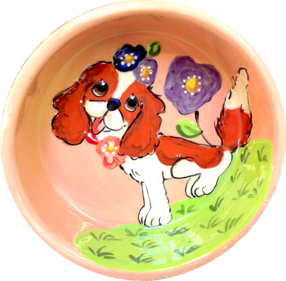Sweet King Charles Blenheim sitting in flowers dog bowl