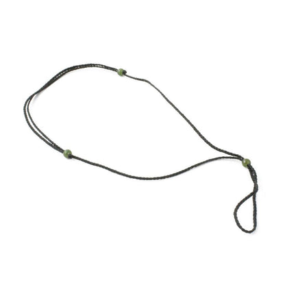 Thick dark brown cord necklace with jade bead accents arranged in a loose loop