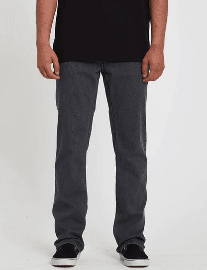 Dark gray men's denim jeans, casual fit, paired with black sneakers for watersports lifestyle