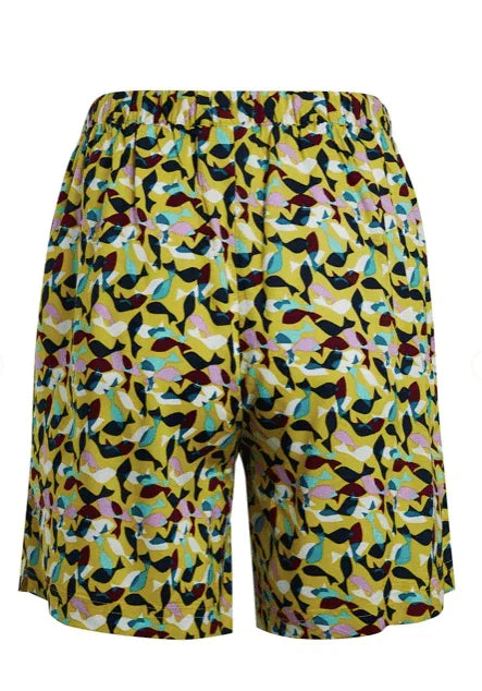 Yellow patterned surf shorts with colorful leaf design for watersports
