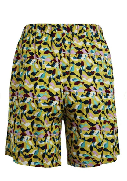 Yellow patterned surf shorts with colorful leaf design for watersports