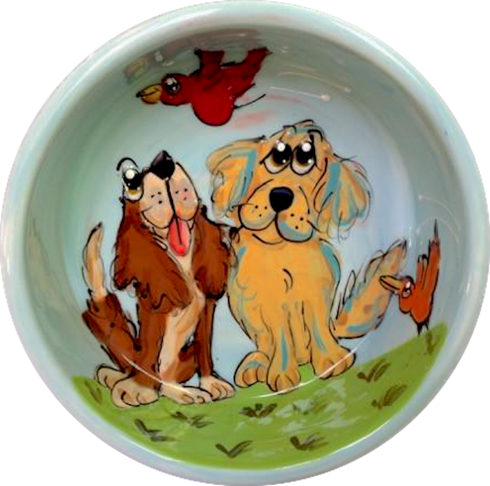image of ceramic dog bowl hand painted by Debby Carman featuring Labrador retriever and cavalier King Charles looking amazed by bird flying overhead