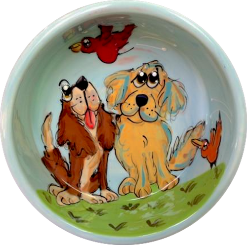 image of ceramic dog bowl hand painted by Debby Carman featuring Labrador retriever and cavalier King Charles looking amazed by bird flying overhead