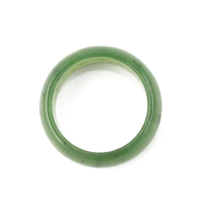 Green jade wide band ring on white background.